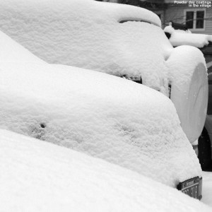 Snow-covered cars midday on a March powder day in the Wentworth Condominium area in the Bolton Valley Village