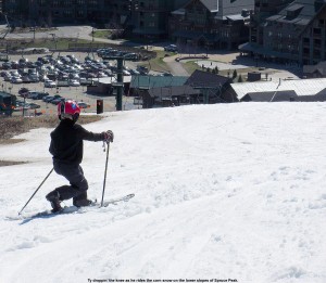 An image of Ty Telemark skiing in spring snow on the lower slopes of Spruce Peak at Stowe Mountain Resort in Vermont