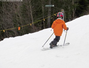 An image of Ty Telemark skiing in spring snow on Sherman's Pass at Bolton Valley Ski Resort in Vermont