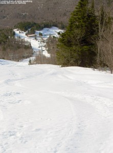 An image of recent ski tracks in the snow left by a recent April snowstorm on the steep Spillway trail at Bolton Valley Ski Resort in Vermont