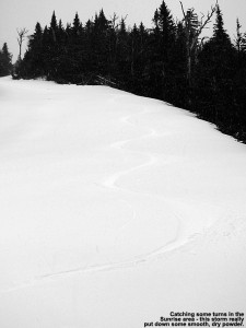 An image of ski tracks in late April powder on the Sunrise trail at Stowe Mountain Resort in Vermont