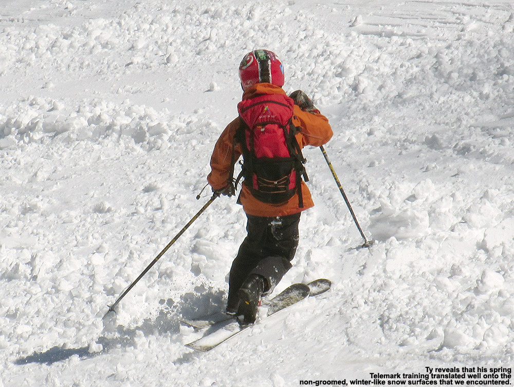 An image of Ty Telemark skiing in some tracked snow at Stowe Mountain Resort in Vermont after an April snowstorm 