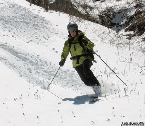 An image of E skiing some powder off the edge of North Slope at Stowe Mountain Resort in Vermont after an April snowstorm