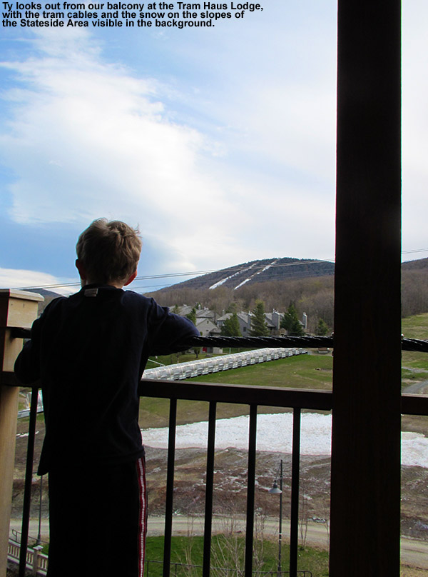 An image of Ty looking out from the balcony of our room in the Tram Haus Lodge at Jay Peak Ski Resort in Vermont