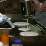 An image of pancake batter being dispensed for the all-you-can-eat breakfast at the Twin Mountain, New Hampshire KOA Campground