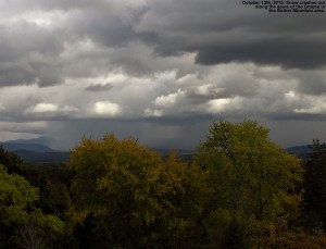 An image of early-season October snow falling in front of Bolton Mountain in Northern Vermont, obscuring the Green Mountains from view