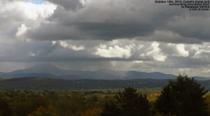 An image of Camel's Hump in Vermont with snowfall just starting to appear around it