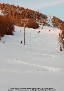 An image of skiers making their way up the Liftline trail at Stowe Mountain Resort to catch some early morning powder turns