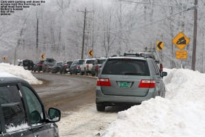 An image of cars parked along the Bolton Valley Access Road  after the upper parking lots at Bolton Valley Ski Resort were filled