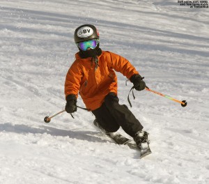 An image of Ty Telemark skiing on a warm January day in soft snow at Bolton Valley Resort in Vermont