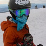 An image of Ty with a handkerchief mask outside the Octagon at the top of the Fourrunner Quad at Stowe Mountain Ski Resort in Vermont