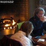 An image of Apres Ski time in front of the fire at the Spruce Camp Bar at Stowe Mountain Resort in Vermont