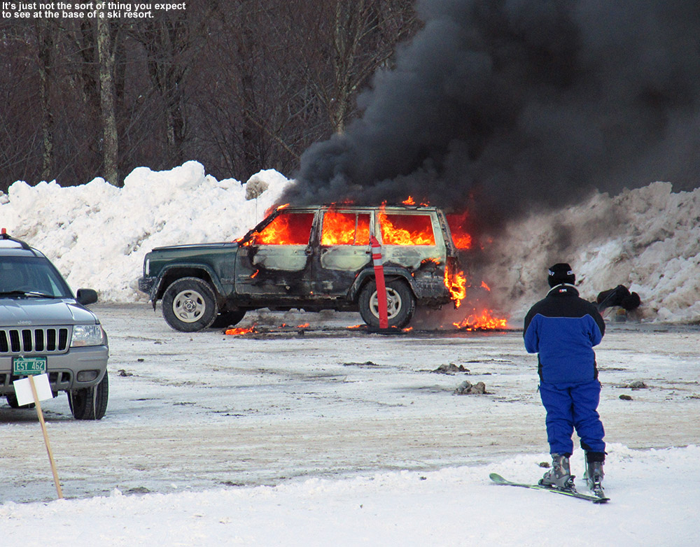 An image of a burning SUV in the Midway parking lot at Stowe Mountain Resort in Vermont