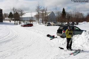 An image of our car parked along the edge of the Broadway trail in Bolton Valley's Nordic skiing area with Erica unloading backcountry ski gear in preparation for a ski tour