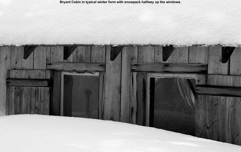 An image of Bryant Cabin in the Bolton Valley backcountry showing the snow depth outside reaching halfway up the windows 