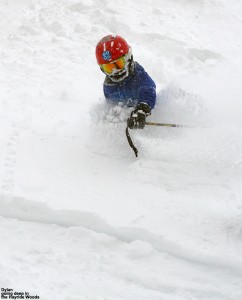 An image of Dylan skiing in powder snow above his waist in the Hayride Trees at Stowe Mountain Resort in Vermont