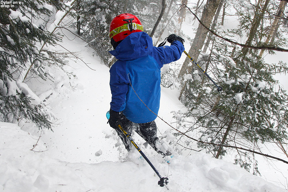 An image of Dylan dropping off a cliff into the powder while skiing at Bolton Valley Resort in Vermont