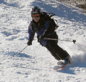 An image of Jay in a Telemark turn in spring snow on the Gondolier trail at Stowe Mountain Ski Resort in Vermont