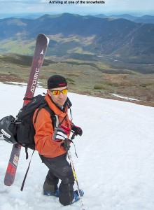 An image of Jay carrying his skis on his pack on one of the snowfields on the east side of Mt. Washington in New Hampshire