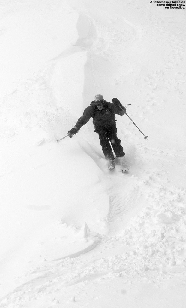 An image of a skier  on the Nosedive trial at Stowe Mountain Resort in Vermont during a Memorial Day Weekend snowstorm