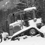 An image of snow-covered bulldozer between the Perry Merrill and Gondolier Ski Trails at Stowe Mountain Resort in Vermont during an October storm