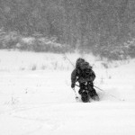 An image of Ty skiing away in an October snowstorm at Stowe Mountain Resort in Vermont