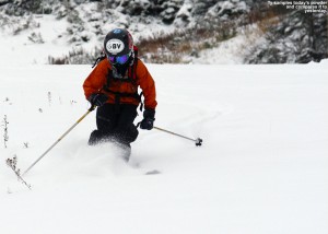 An image of Ty skiing powder on the Perry Merrill trail at Stowe in October