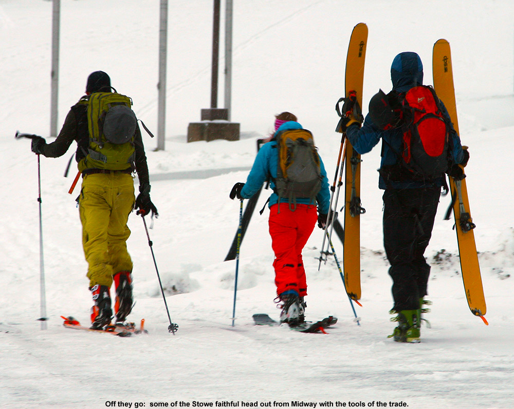An image of skiers heading out from the Midway parking lot  at Stowe for a November ski tour