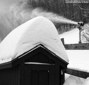 An image of snow on the roof of a shed with a snowgun in the background at Stowe Mountain Ski Resort in Vermont