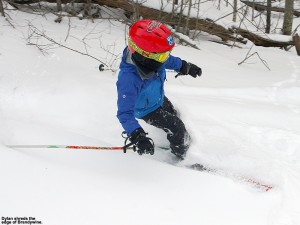 An image of Dylan skiing powder along the edge of the Brandywine trail at Bolton Valley Ski Resort in Vermont