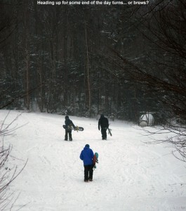 An image of snowbaorders hiking up the Lower Turnpike Trail at Bolton Valley Ski Resort in Vermont