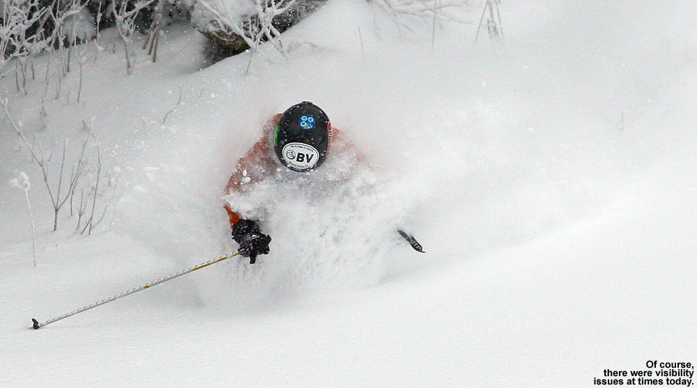 An image of Ty getting a face shot of powder on the Wilderness Lift Line trail at Bolton Valley Ski Resort in Vermont