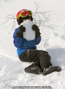 An image of Dylan playing with a chunk of snow at the top of the Gondola at Stowe Mountain Resort in Vermont