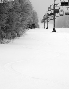 An image of a ski track in powder snow beneath the Wilderness Lift at Bolton Valley Resort in Vermont