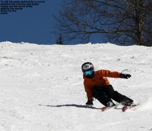 An image of Ty carving a turn with his had down on the spring snow at Bolton Valley Ski Resort in Vermont