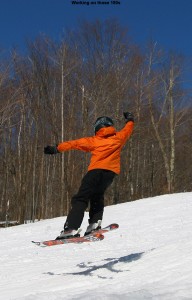 An image of Ty doing a 180 jump in spring snow at Bolton Valley Ski Resort in Vermont