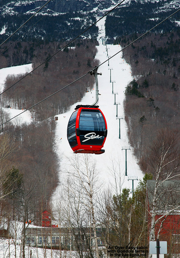 An image of the Over Easy Gondola at Stowe Mountain Ski Resort in Vermont with some of the Mt. Mansfield ski trails in the background