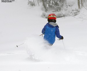 An image of Dylan skiing powder snow on the Duck Walk trail in April at Stowe Mountain Resort in Vermont