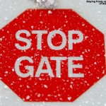 An image of a frosty "Stop Gate" sign at the top of the Lookout Double Chairlift at Stowe Mountain Resort in Vermont