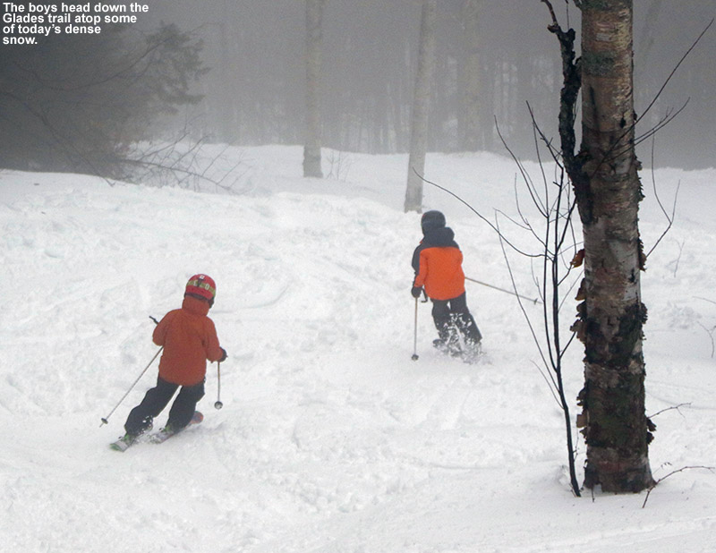 An image of Ty and Dylan skiing some dense snow on the Glades trail at Bolton Valley Ski Resort in Vermont