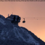 An image of the Jay Peak tram docking at its summit station back lit by light of the setting sun