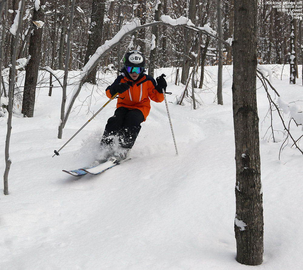 An image of Ty skiing udner and arched tree in the Lower Villager Trees at Bolton Valley Ski Resort in Vermont