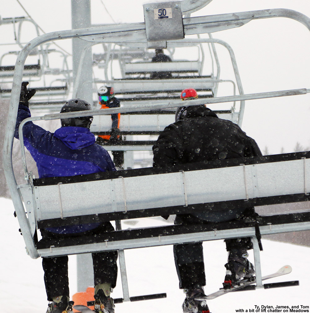 An image of Ty, Dylan, Tom, and James riding the Meadows Quad Chair at Stowe Mountain Ski Resort in Vermont