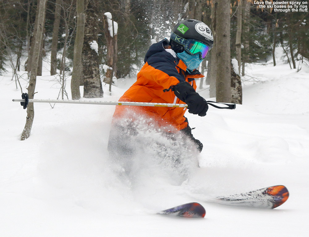An image of Ty spraying powder with his skis in the KP Glades area of Bolton Valley Ski Resort in Vermont