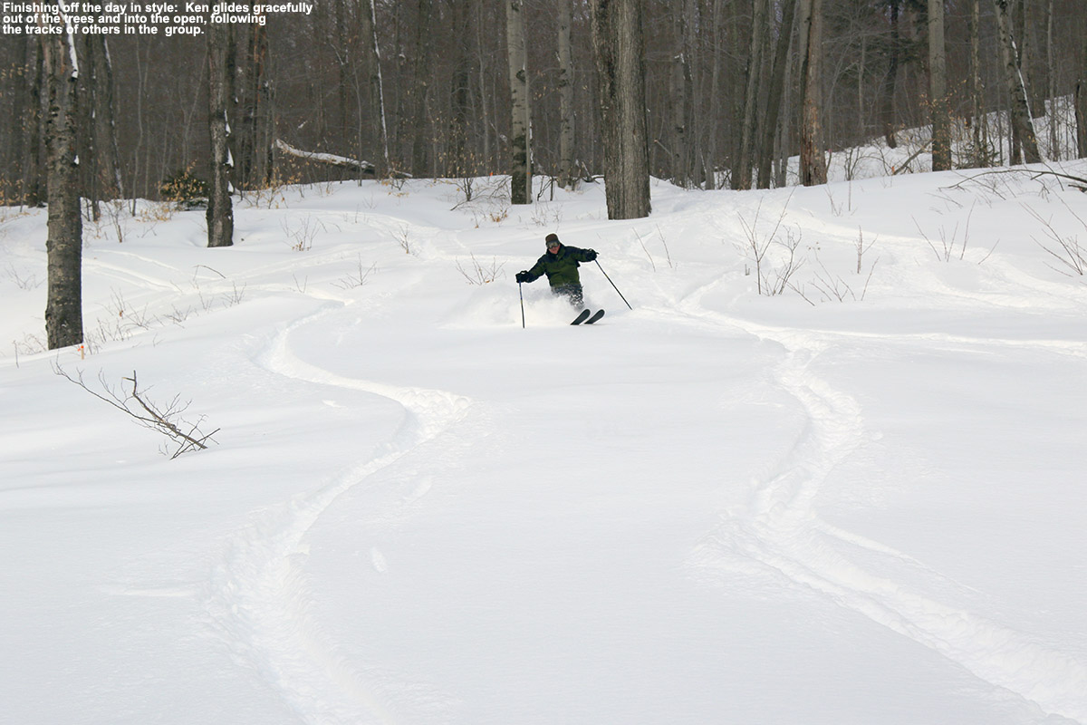 An image of Ken skiing dry powder as he comes out of the trees and into the open on Spruce Peak at Stowe Mountain Resort in Vermont