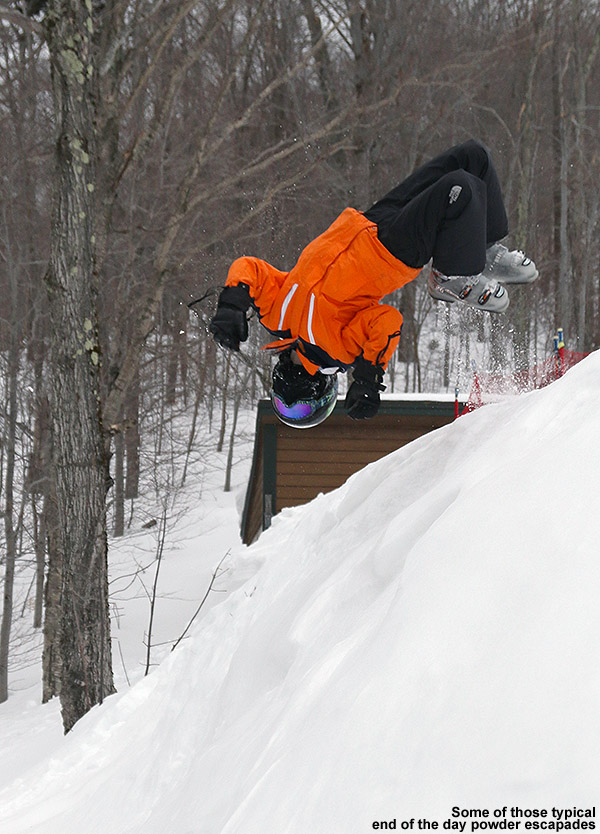 An image of Ty doing a back flip into some powder at the base of Stowe Mountain Ski Resort in Vermont