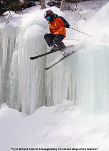 An image of Ty bouncing off the second tier of an ice waterfall in the trees near Angel Food at Stowe Mountain Resort in Vermont