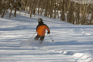 An image of Ty skiing powder snow on the Snowflake Bentley trail at Bolton Valley Ski Resort in Vermont