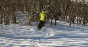 An image of Erica skiing a little powder on the Snowflake Bentley trail at Bolton Valley Ski Resort in Vermont
