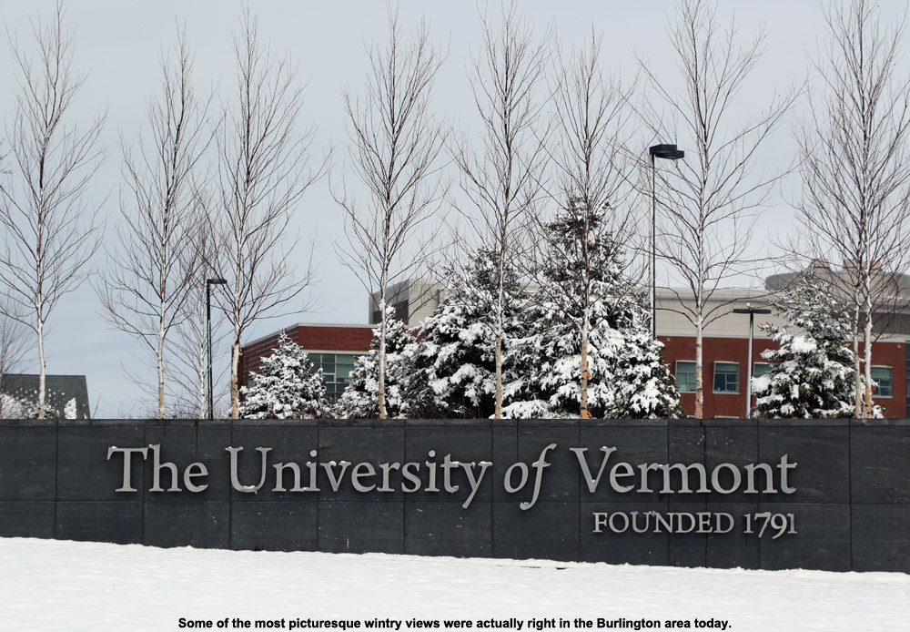 An image of a sign for the University of Vermont with a coating of fresh snow